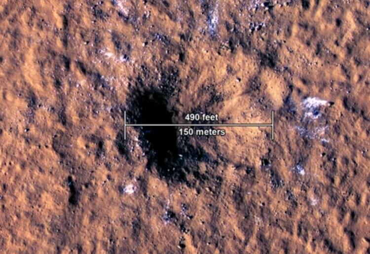 Вода на экваторе Марса. Вокруг кратера видны крупные фрагменты водяного льда. Фото.