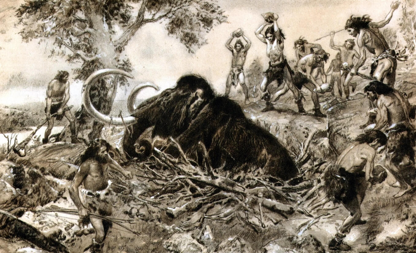 Ловушка в виде ямы для животных. Древние люди забивают камнями мамонта, который угодил в охотничью яму. Фото.