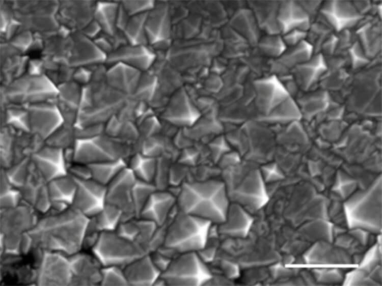 The fastest way to create diamonds. Diamond film grown in liquid metal under a microscope. Image source: scientific journal Nature. Photo.