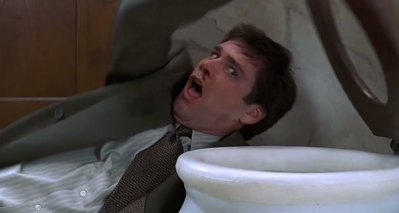 Онемение ног в туалете. С онемевшими от туалета ногами можно запросто упасть. Кадр из фильма «Лжец, лжец». Фото.